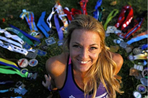 Julie Weiss, surrounded by her marathon medals