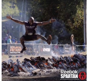 Roodley flying through the air at a Spartan Race.