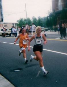 A very pregnant Vanessa trying to catch her sister at the Peachtree 10k.