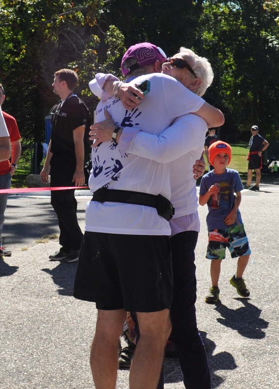 Bill hugging his mother at the marathon finish line. 