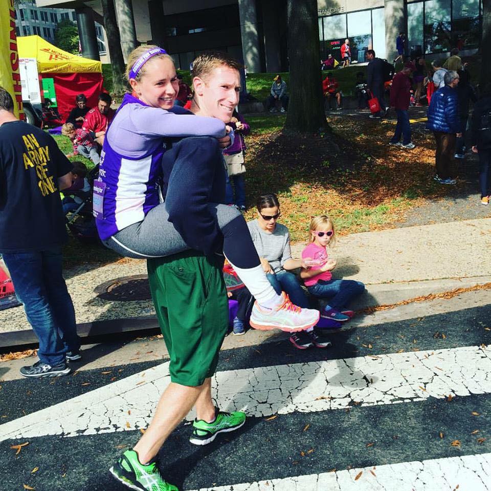 Katie with her husband, Joe, who carries her after each marathon finish.